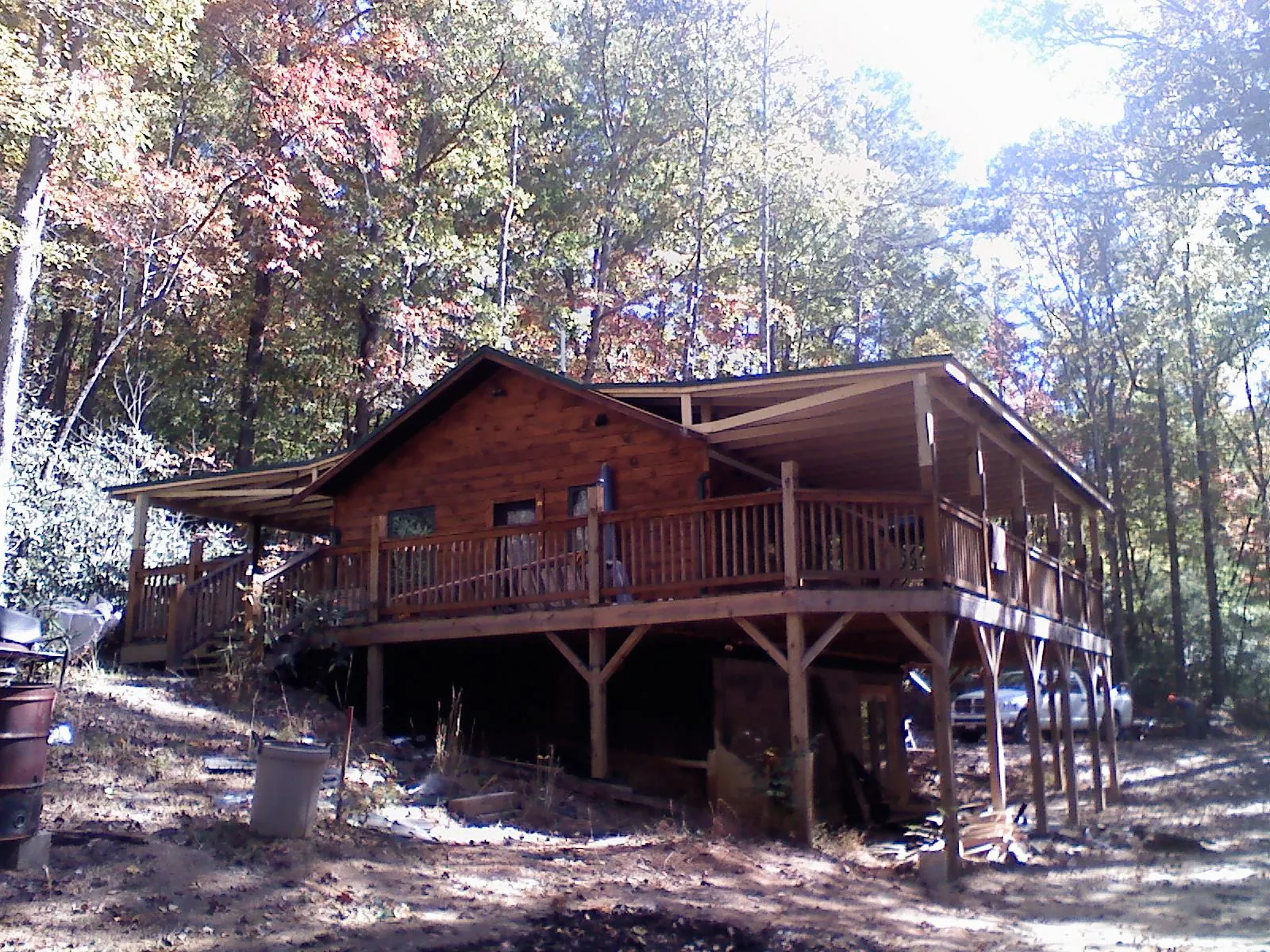 Log cabin with a wraparound porch and metal roof in the fall in Chantilly